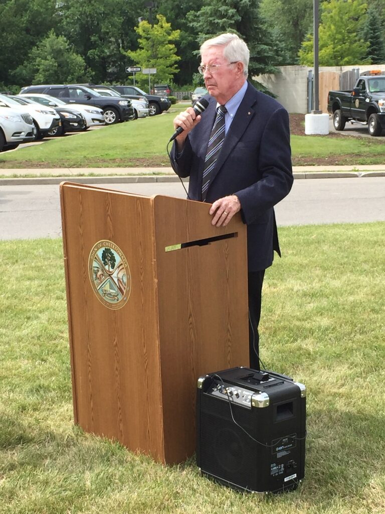 An image of Hugh Neeson giving a speech for the dedication of the Gardenville Plant historical site marker.